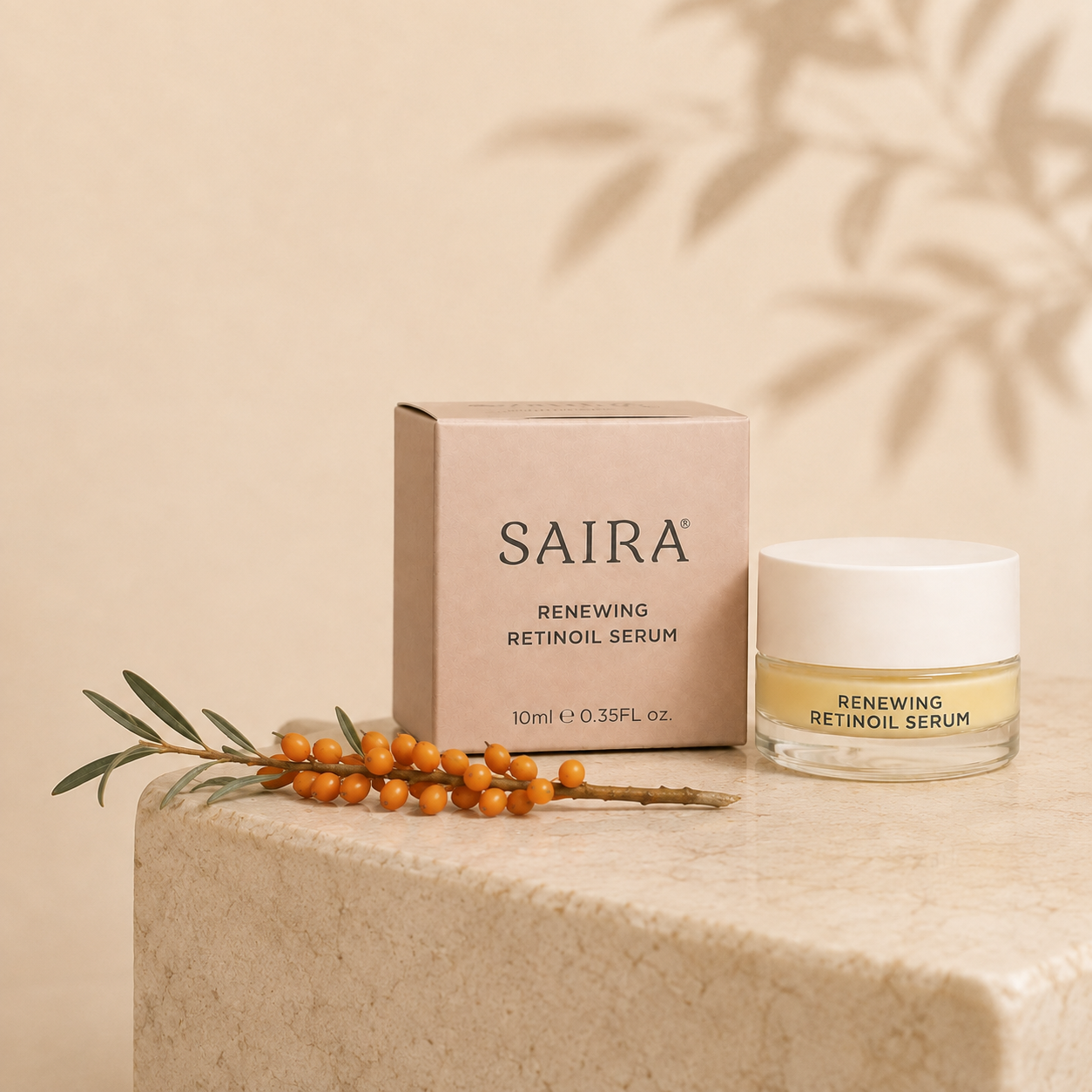 SAIRA Renewing Retinoil Serum shown with its beige product box and a clear jar with a white lid, styled on a stone pedestal with orange berries and leaf shadows against a warm beige background.