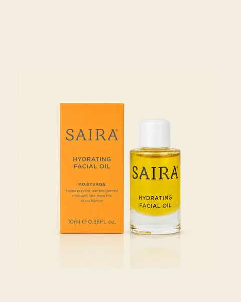 SAIRA Hydrating Facial Oil 10ml bottle next to its orange packaging box, set against a warm cream background.