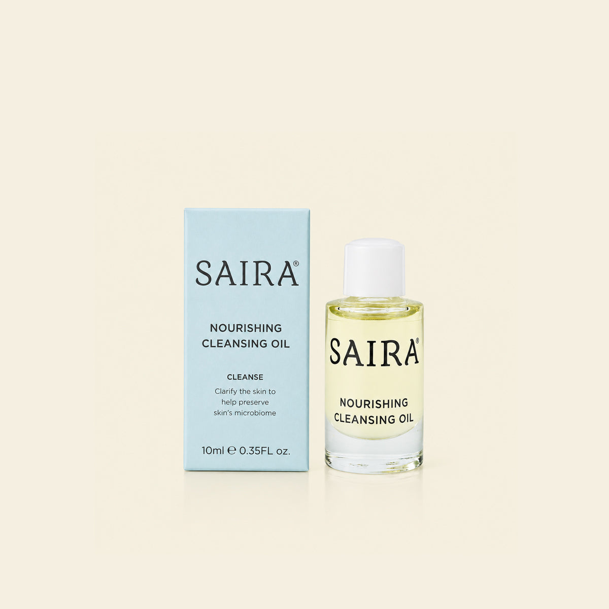 SAIRA Nourishing Cleansing Oil shown with its light blue outer box and the clear glass bottle containing pale yellow oil, set against a solid cream background.