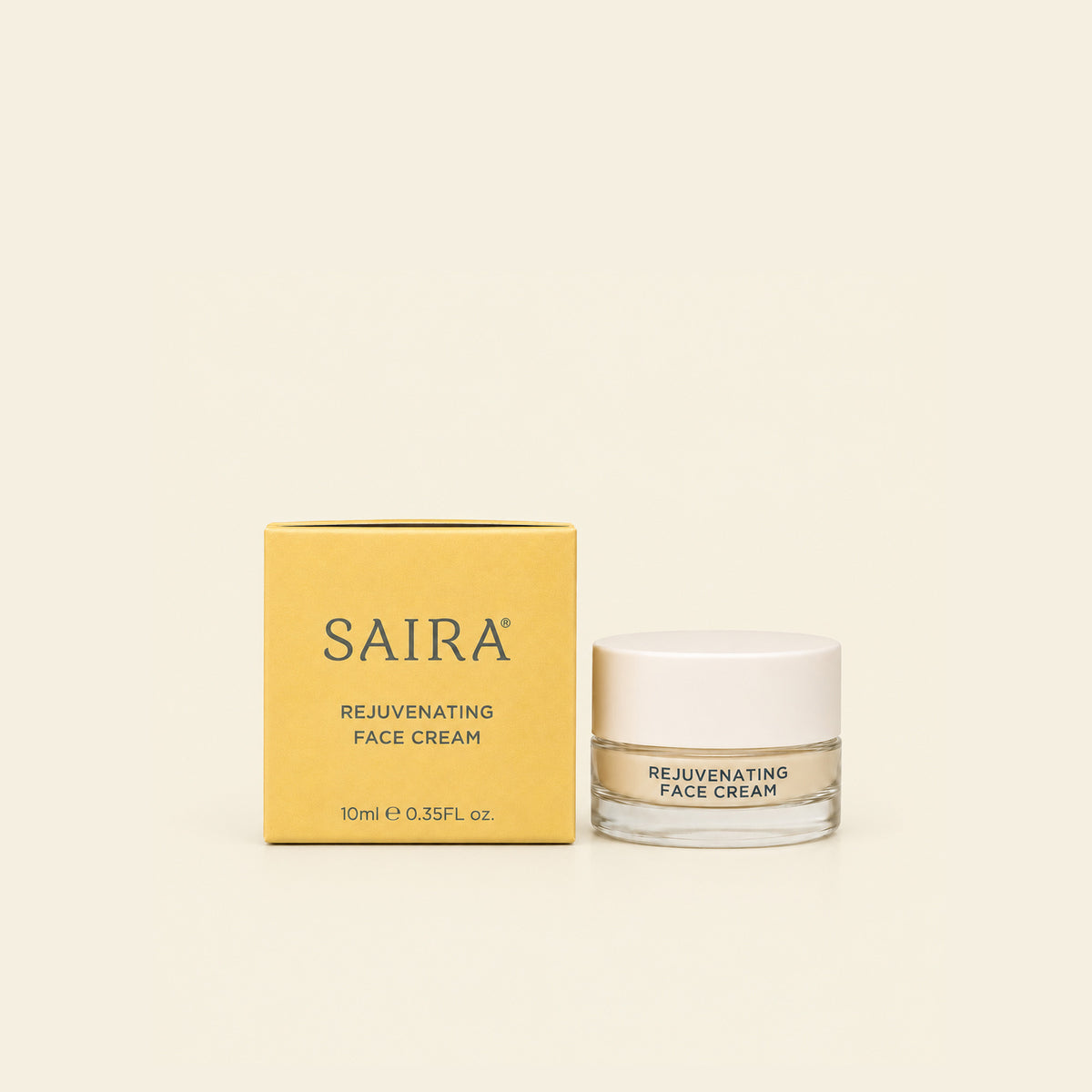 SAIRA Rejuvenating Face Cream shown with its mustard yellow packaging box and a clear glass jar with a white lid on a solid cream-colored background.