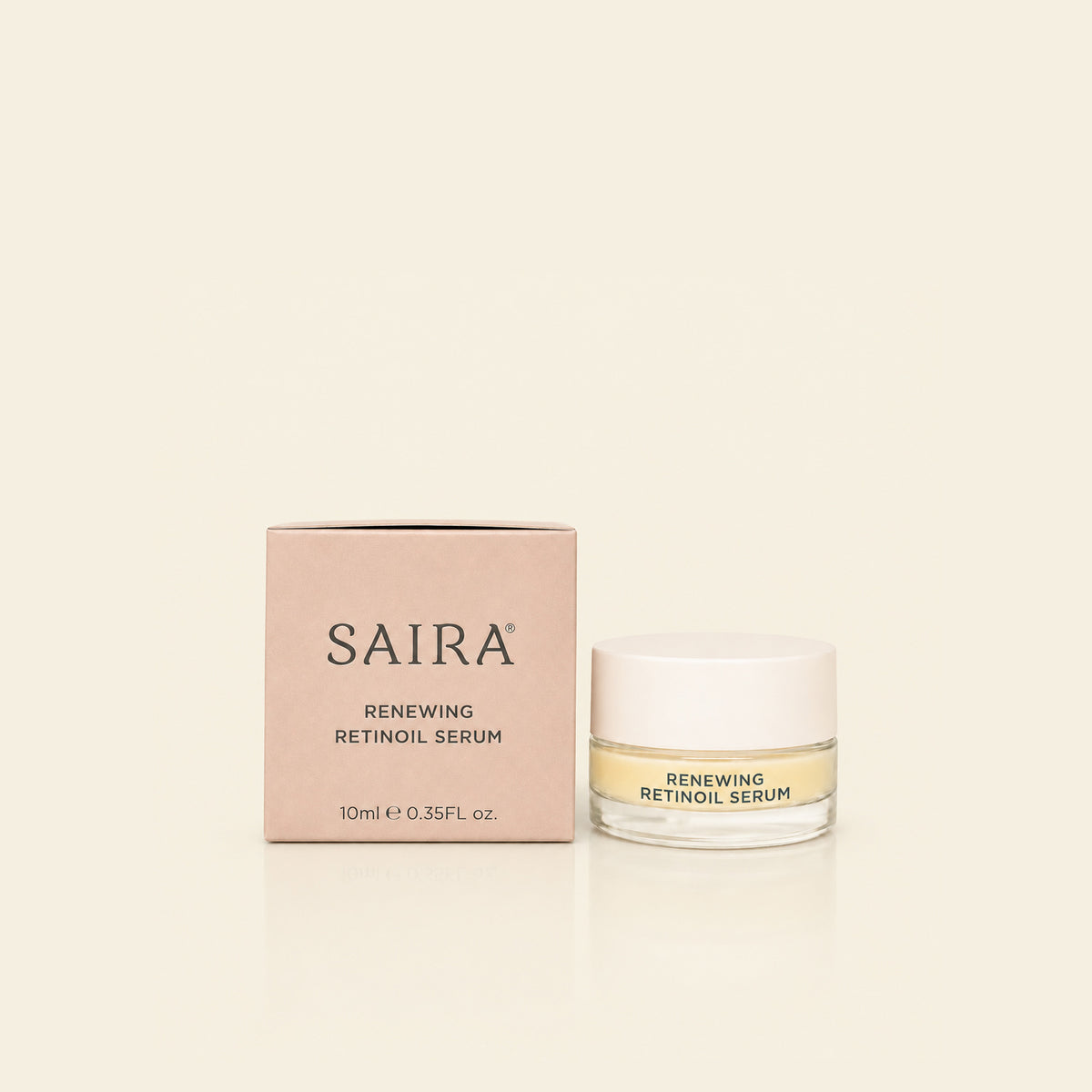 SAIRA Renewing Retinoil Serum shown with its light pink packaging box and a clear glass jar with a white lid on a warm cream background.