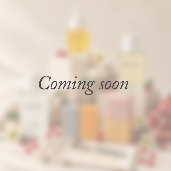 A minimalist placeholder graphic featuring the words 'Coming soon' in a warm orange cursive font, centered on a solid off-white background.
